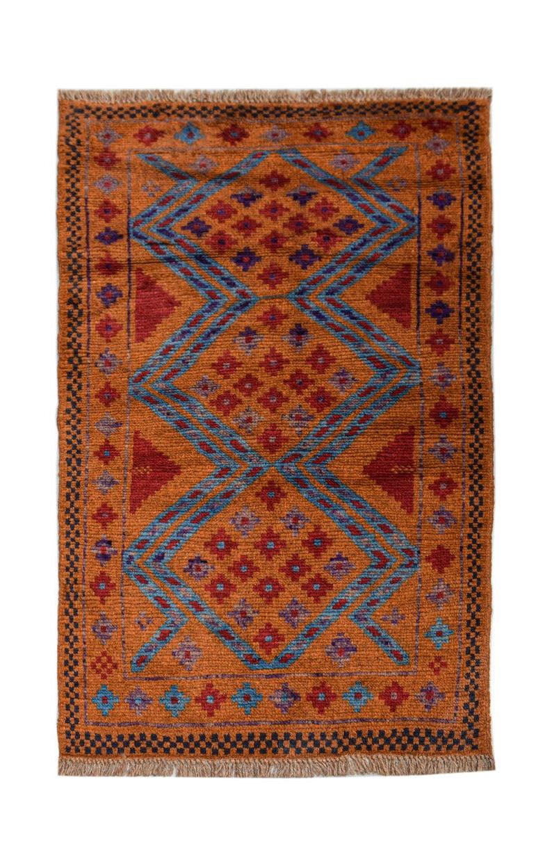 Handmade Afghan Pashm rug featuring a geometric diamond pattern in orange, red, and blue tones.