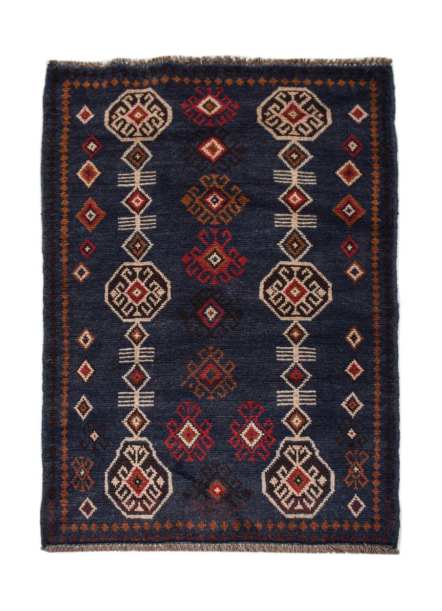 Handmade Afghan Pashm rug featuring geometric tribal patterns in red, brown, and ivory on blue.