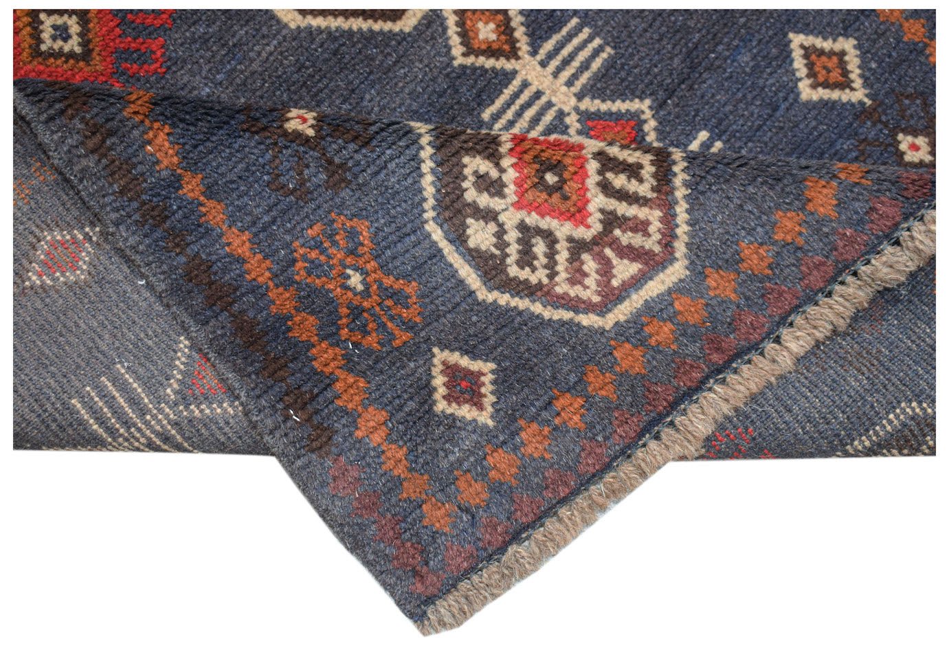Handmade Afghan Pashm rug featuring a dark blue field with traditional tribal geometric patterns.