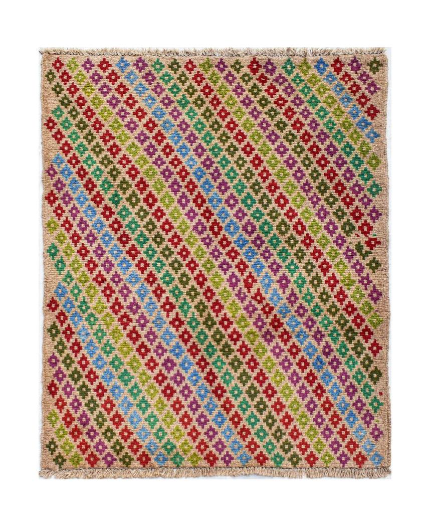 Handmade Afghan Pashm rug featuring a diagonal pattern of colorful geometric floral motifs.