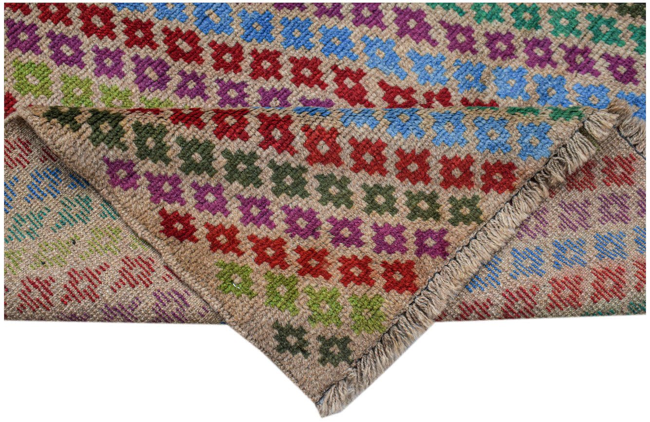Handmade Afghan Pashm rug featuring a geometric floral pattern in vibrant colors on a tan base.