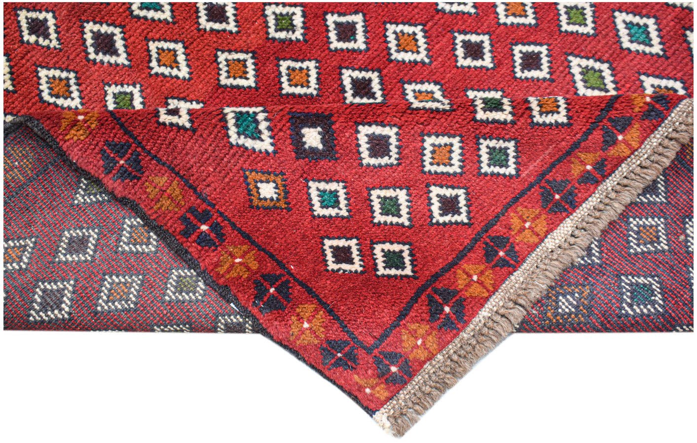 A handmade Afghan Pashm rug featuring a red field with a repeating pattern of small colorful squares.