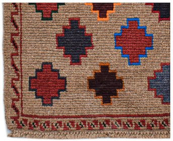 Handmade Afghan Pashm rug featuring a tan field with geometric motifs in red, blue, and brown.