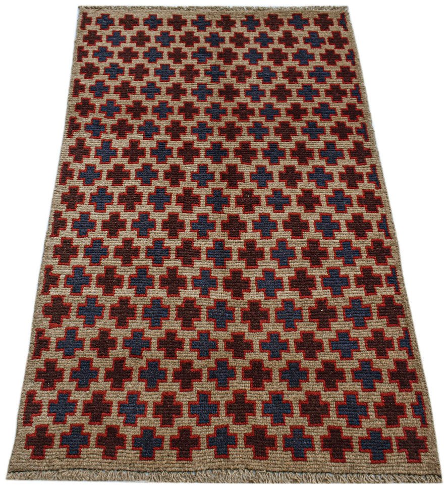 Handmade Afghan Pashm rug featuring a repeating geometric cross pattern in red, blue, and tan.