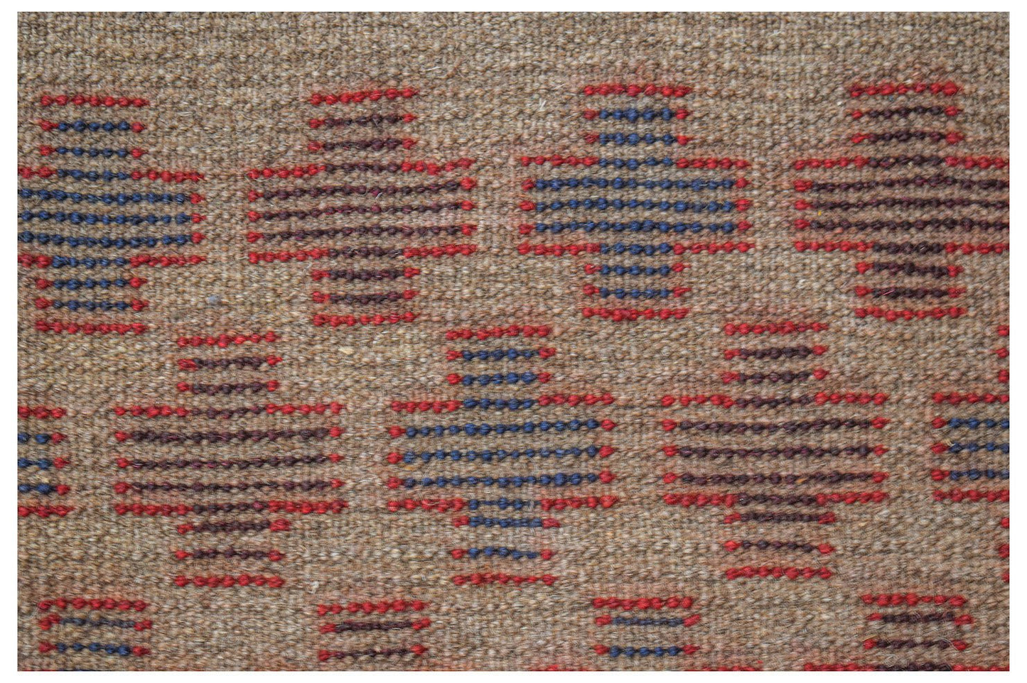Handmade Afghan Pashm rug featuring a repeating geometric pattern in red, blue, and brown wool.