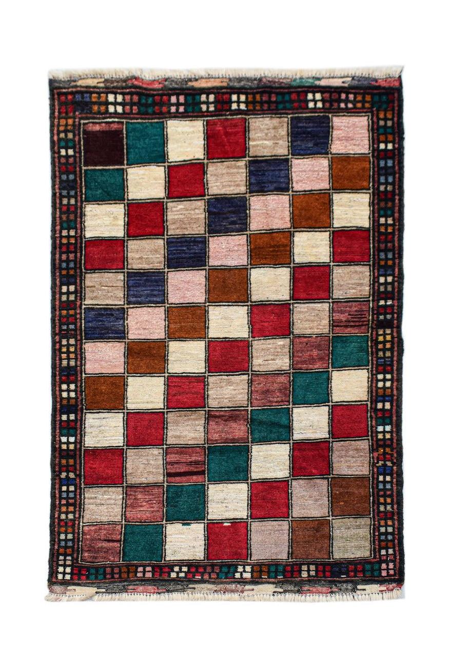 Handmade Afghan Pashm rug featuring a colorful grid pattern of squares in wool.