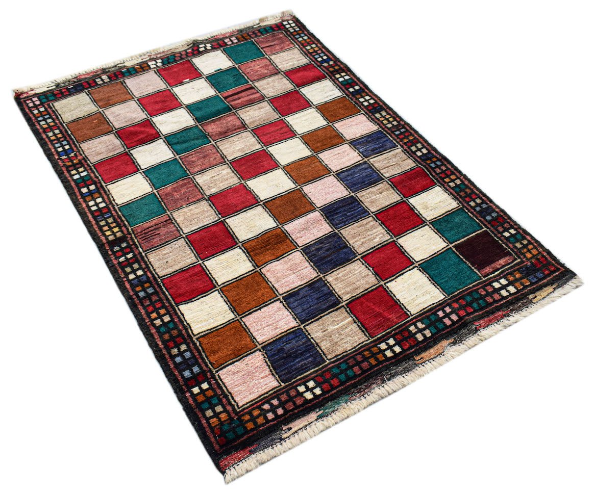 Handmade Afghan Pashm rug featuring a colorful grid pattern of squares in a wool pile.