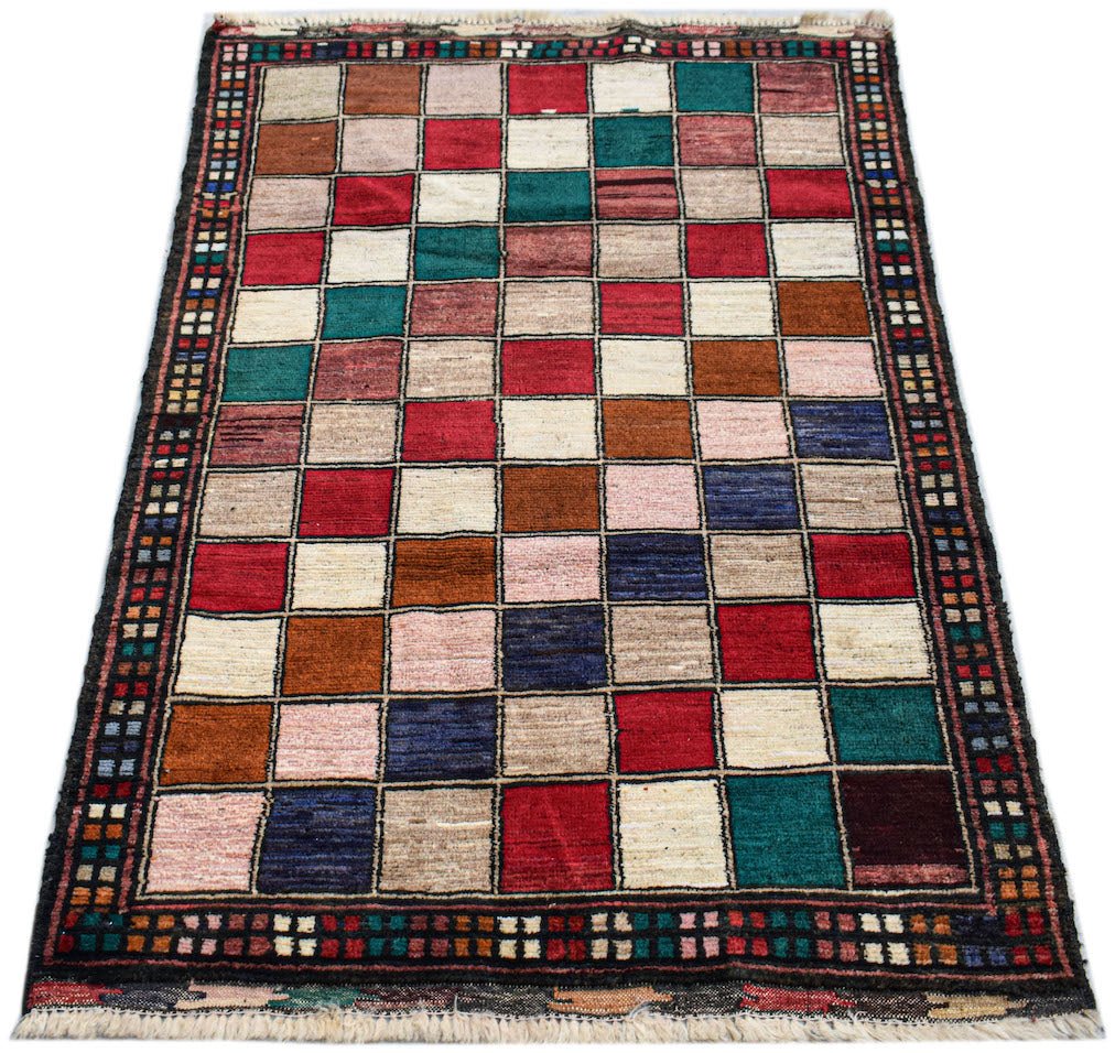 Handmade Afghan Pashm rug featuring a colorful grid pattern of squares in a tribal style.
