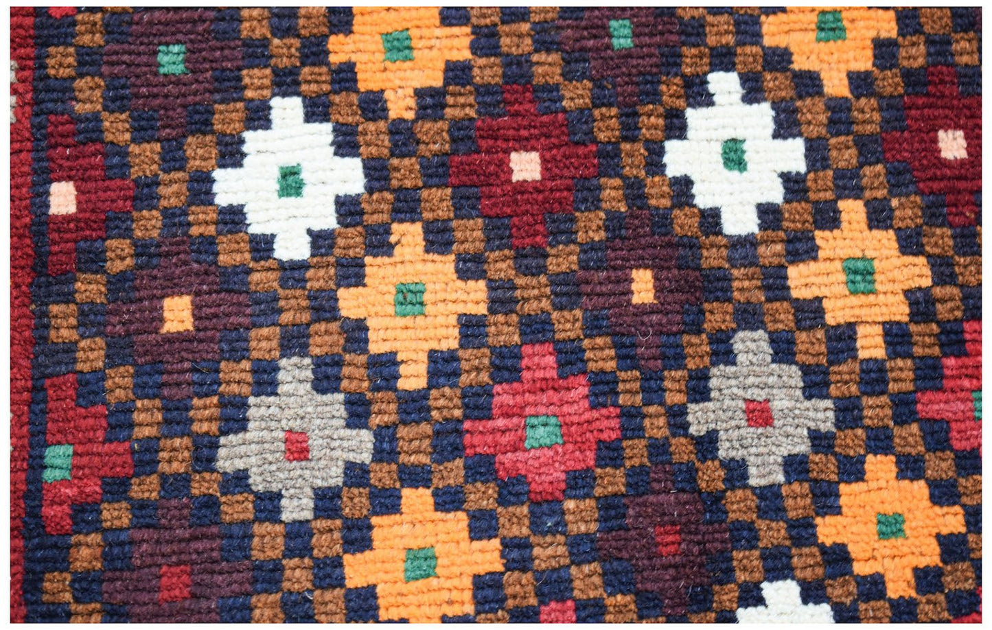 Handmade Afghan Pashm rug featuring a geometric pattern in dark red, blue, brown, and ivory wool.