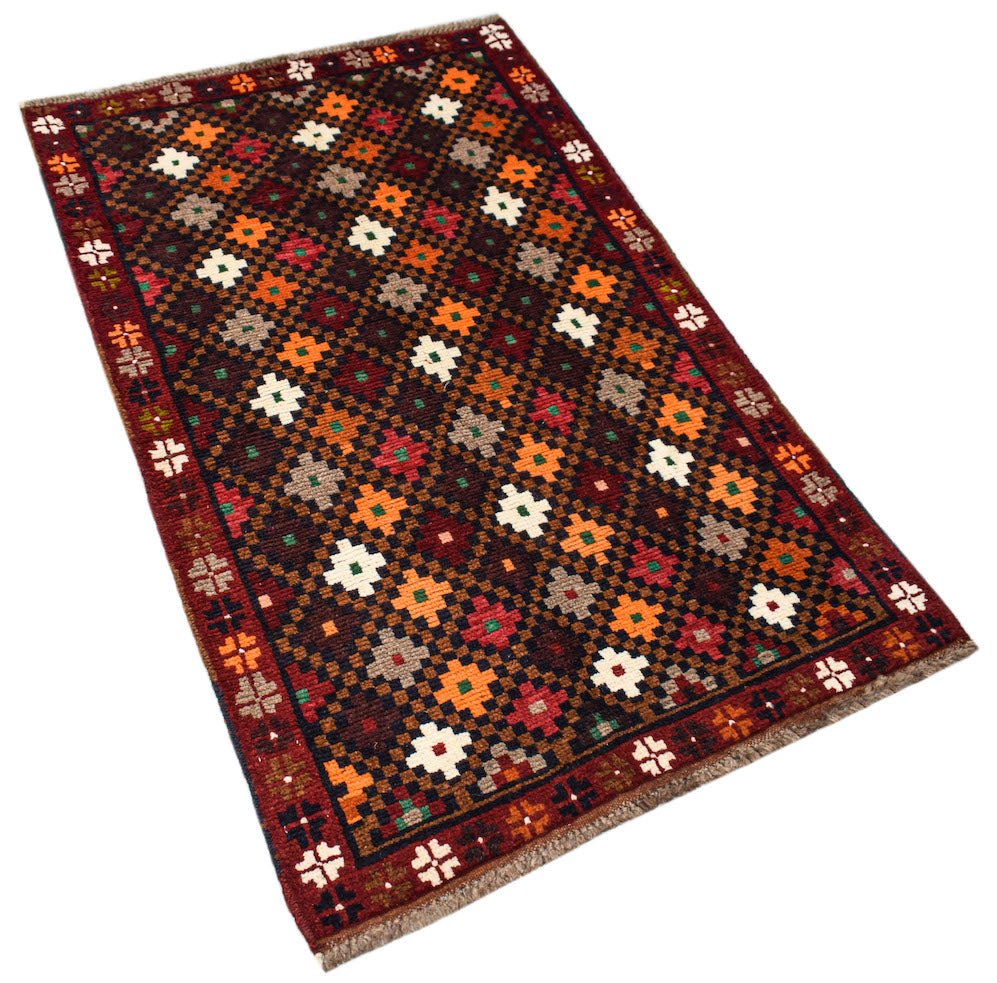 Afghan Pashm rug with a geometric floral pattern in various colors.