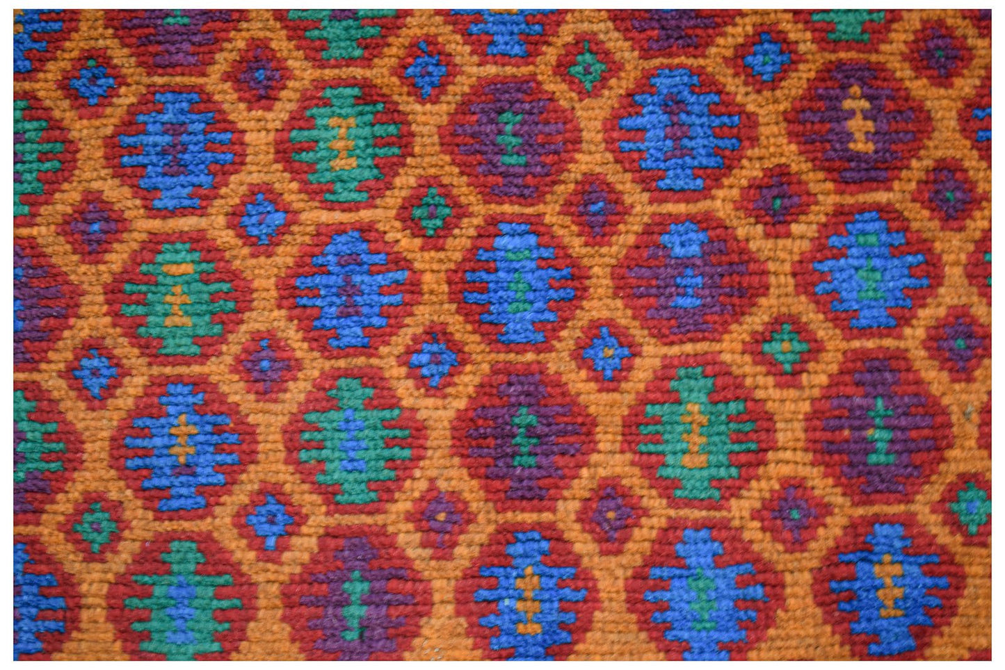 Handmade Afghan Pashm rug featuring a geometric diamond pattern in red, blue, green, and purple.