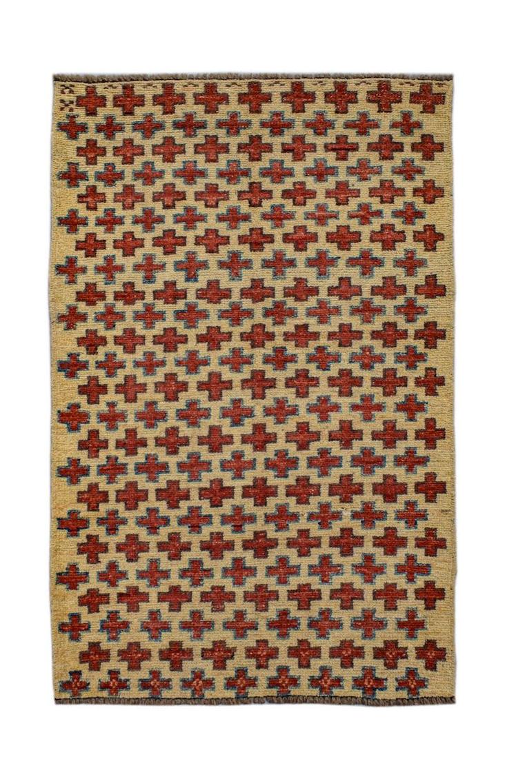 Handmade Afghan Pashm rug featuring a repeating red and blue cross pattern on a beige background.