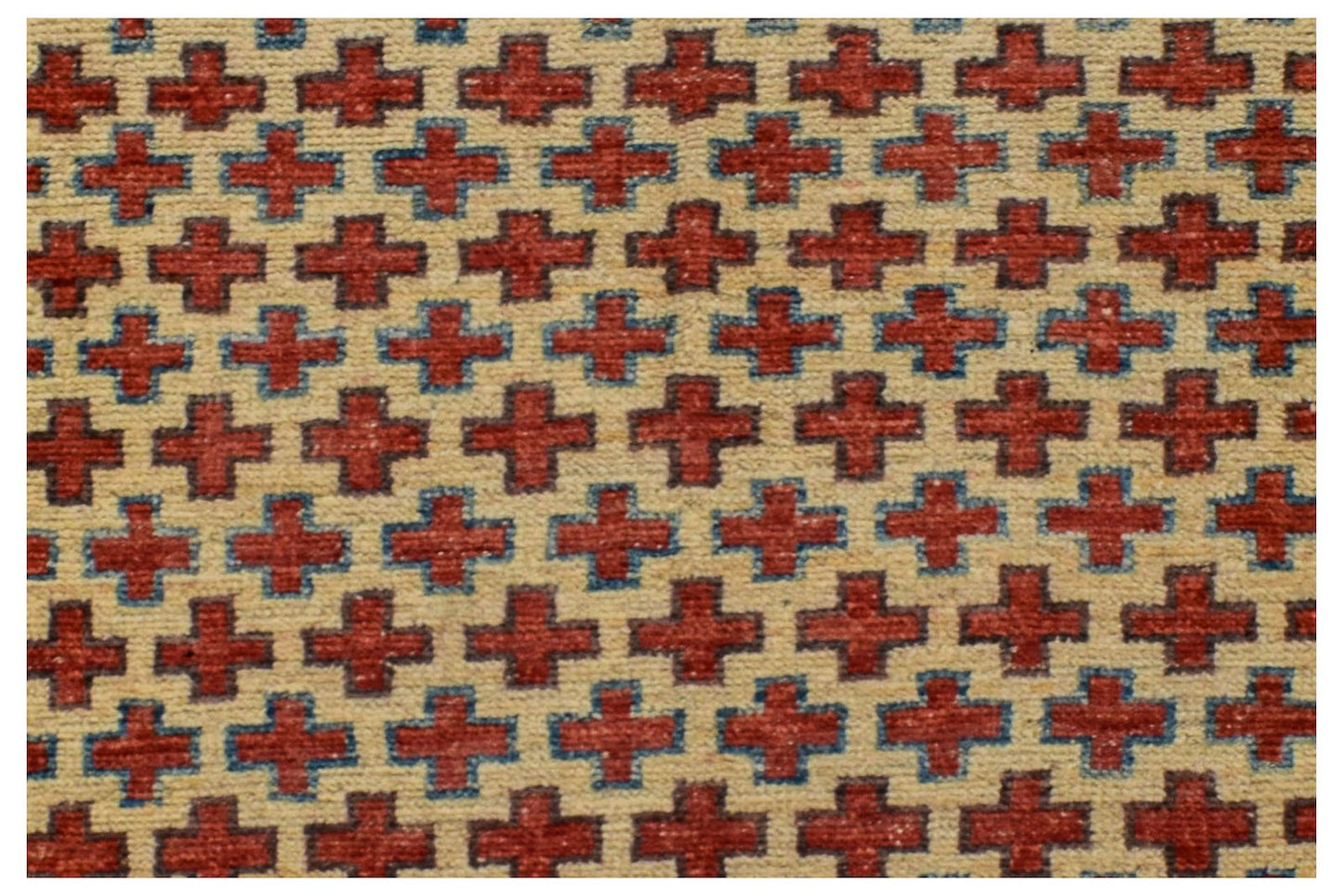 A handmade Afghan Pashm rug featuring a repeating pattern of red crosses on an ivory background.