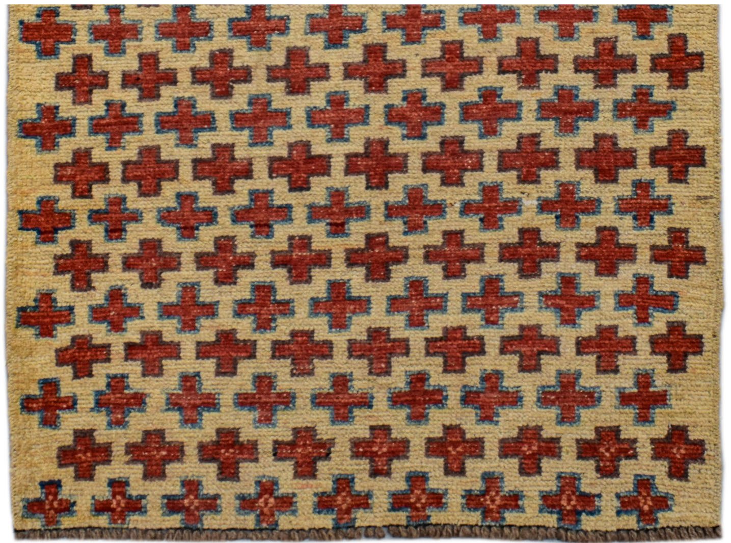 Handmade Afghan wool rug featuring a repeating pattern of red crosses on an ivory background.