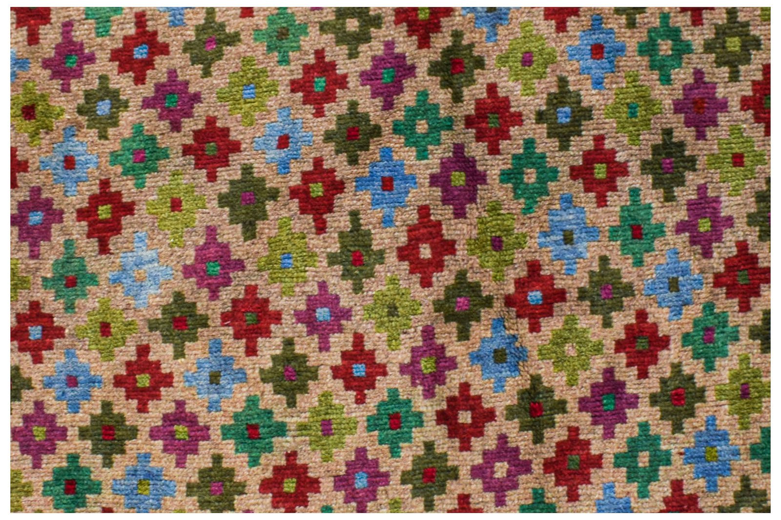 Handmade Afghan Pashm rug featuring a repeating geometric pattern in vibrant multi-colored wool.