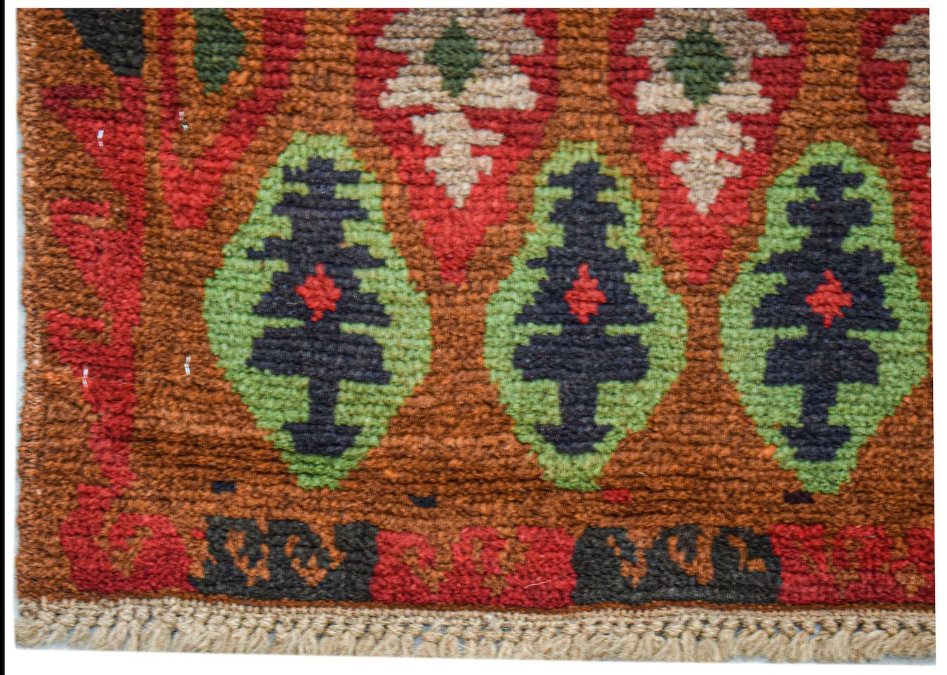 Handmade Afghan Pashm rug featuring a tribal pattern of dark blue and green geometric motifs.