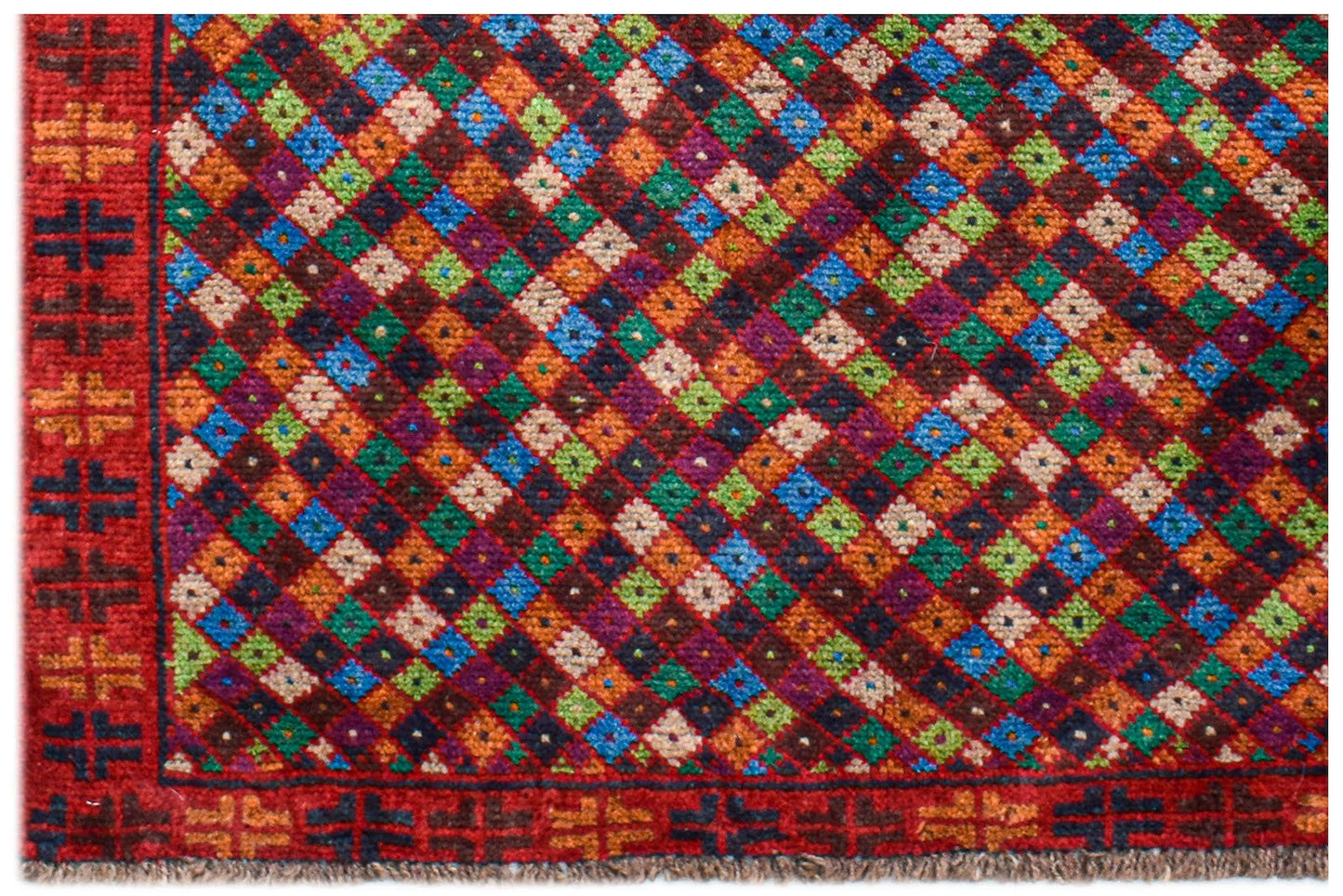 A handmade Afghan Pashm rug featuring a vibrant diamond pattern in red, blue, green, and brown.