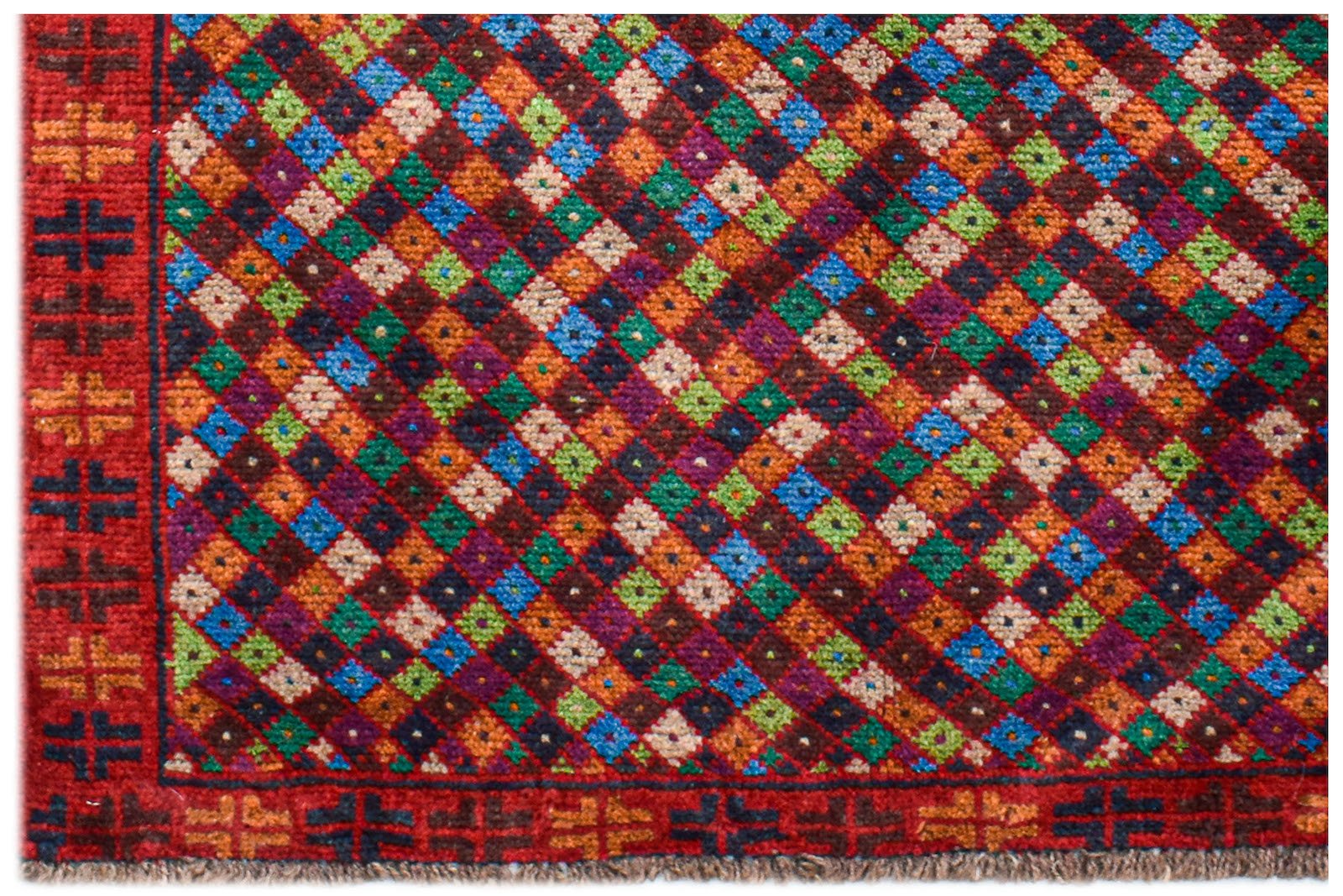A handmade Afghan Pashm rug featuring a vibrant diamond pattern in red, blue, green, and brown.