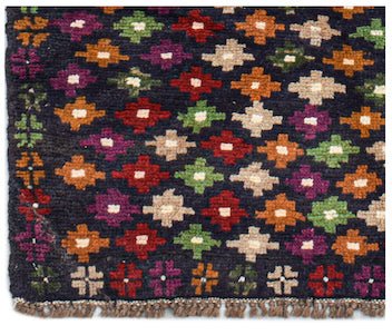 Handmade Afghan Pashm rug featuring a dark blue field with a repeating pattern of colorful motifs.