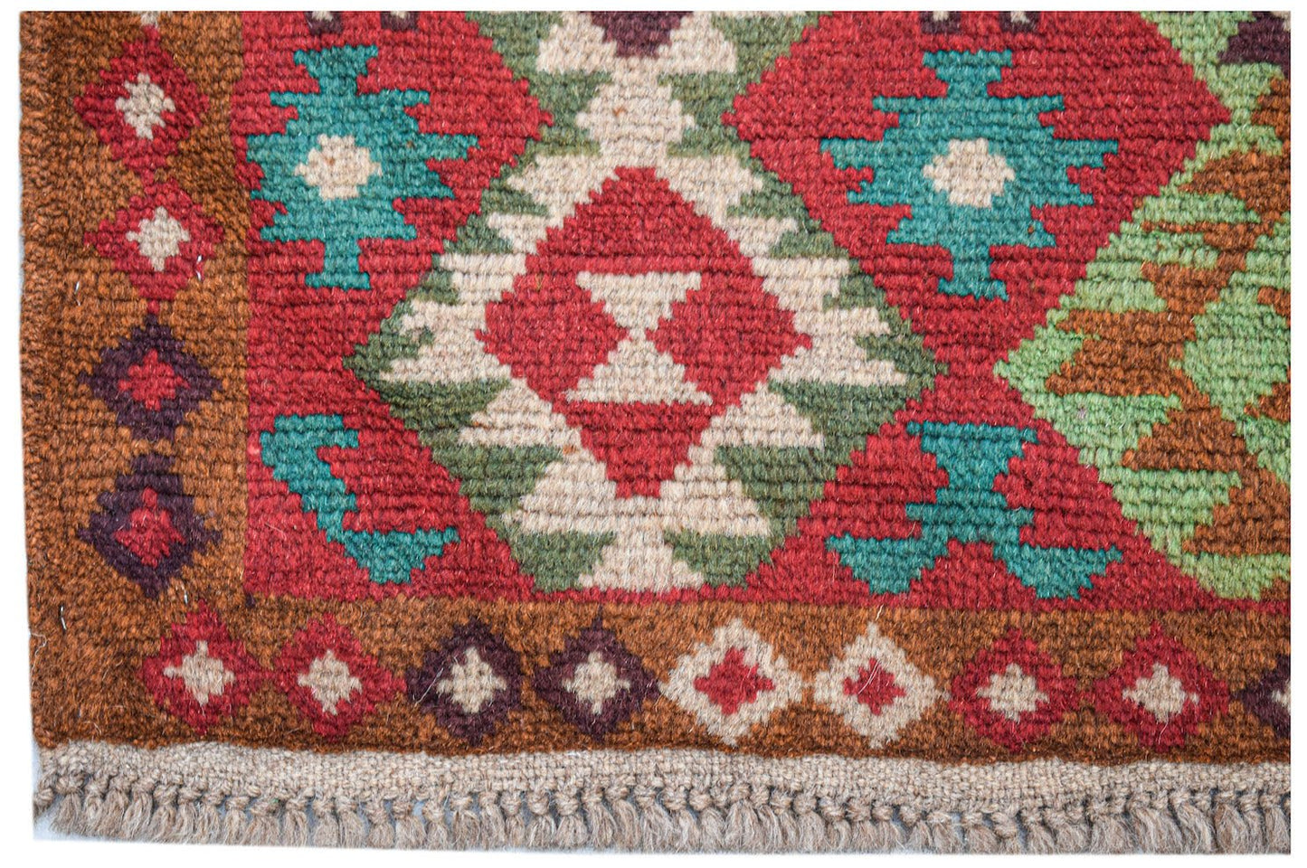 Handmade Afghan Pashm rug featuring a geometric tribal pattern in red, brown, blue, and ivory.