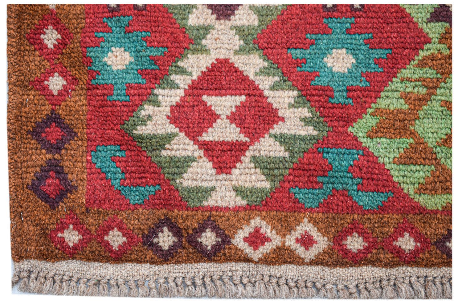 Handmade Afghan Pashm rug featuring a geometric tribal pattern in red, brown, blue, and ivory.
