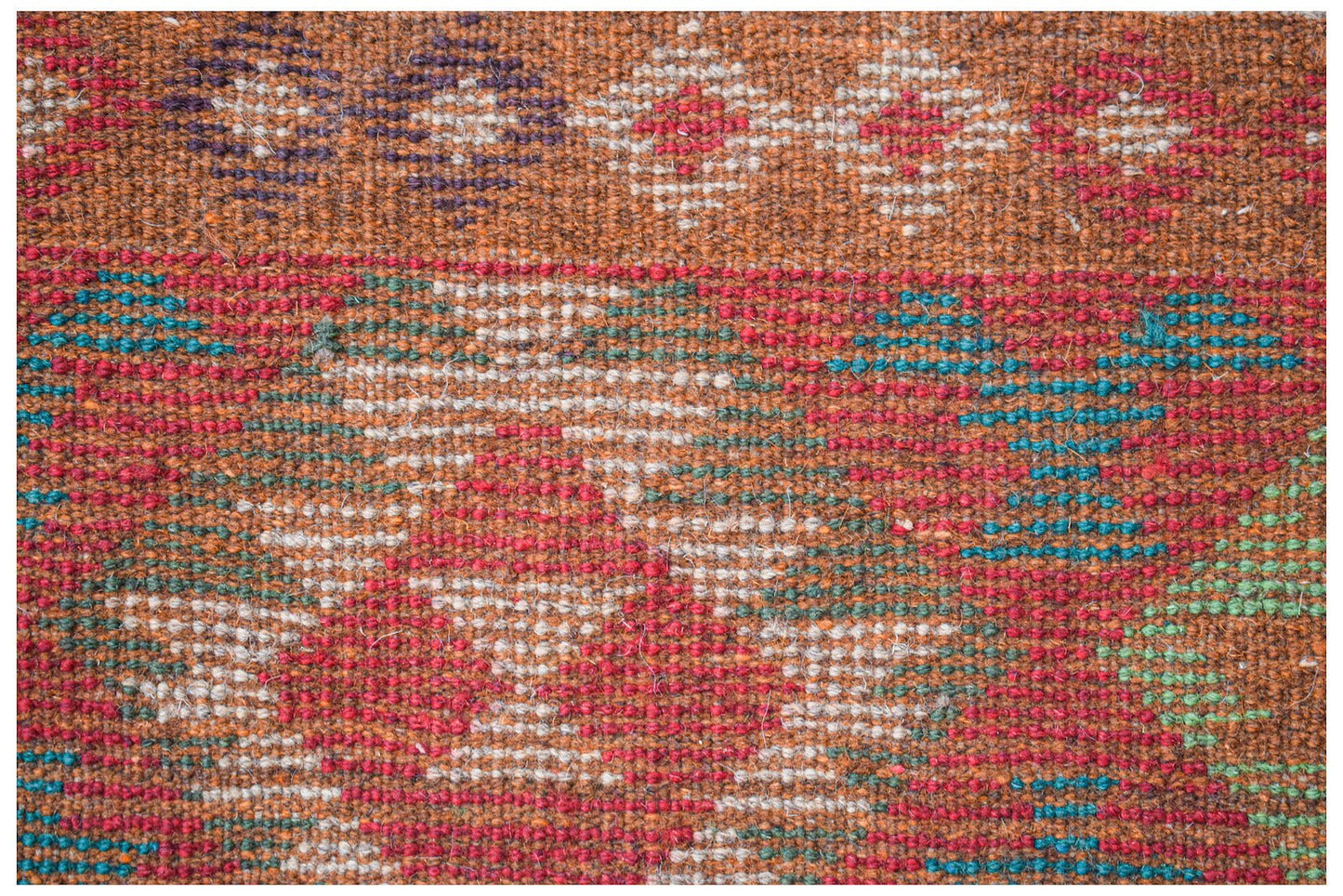 Handmade Afghan Pashm rug featuring a tribal geometric pattern in red, brown, blue, and ivory.