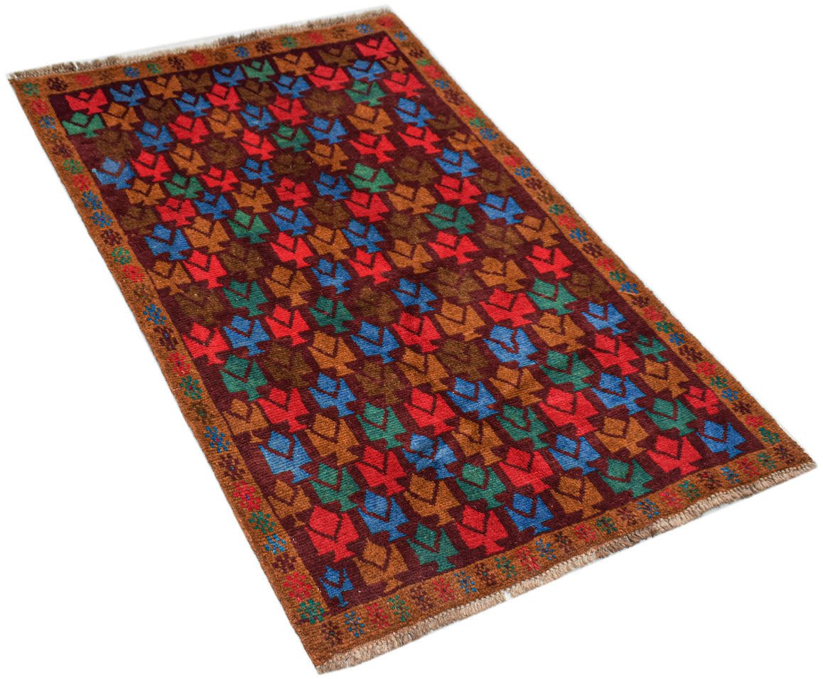 Handmade Afghan Pashm rug featuring a repeating floral pattern in red, blue, and brown wool.