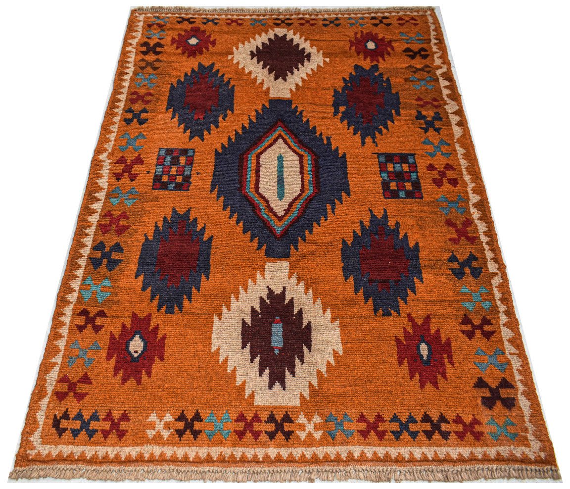 Handmade Afghan Pashm rug featuring geometric tribal patterns in orange, red, blue, and ivory.