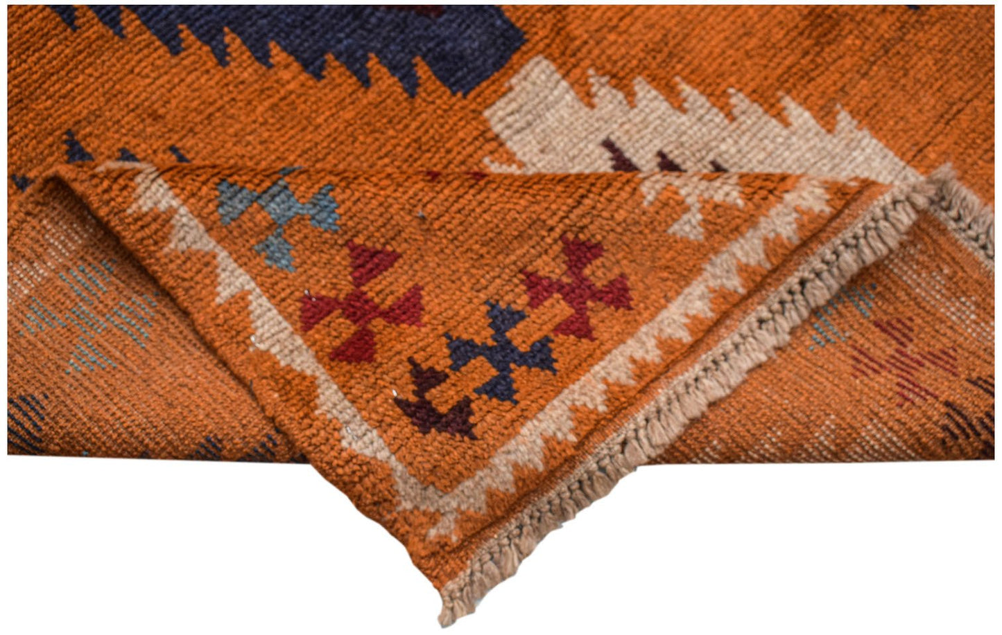 A handmade Afghan Pashm rug featuring a tribal pattern in orange, blue, and ivory wool.