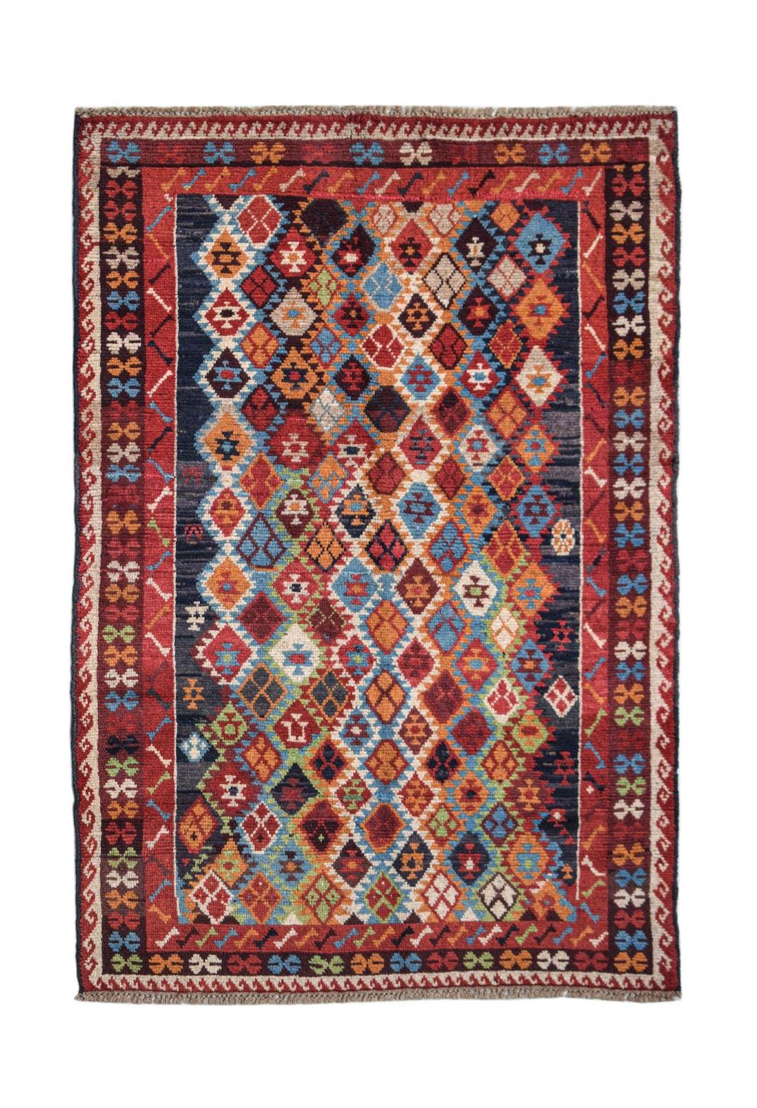 Handmade Afghan Pashm rug featuring a colorful diamond pattern on a dark blue background.