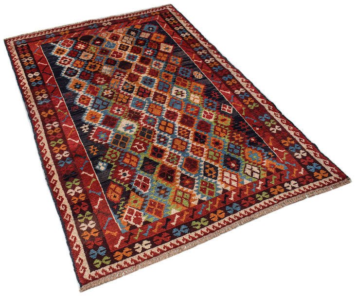 Handmade Afghan Pashm rug featuring a colorful diamond pattern on a dark background.