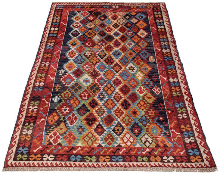Handmade Afghan Pashm rug featuring a colorful diamond pattern on a dark background.