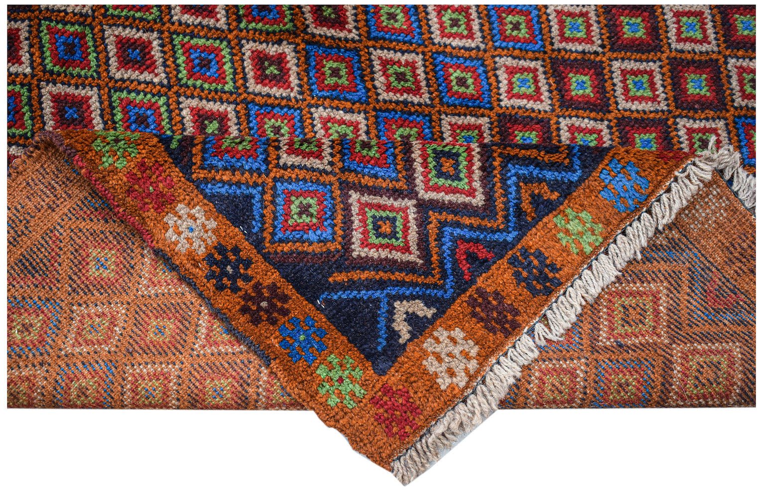 A handmade Afghan Pashm rug featuring a geometric pattern of colorful squares on a dark background.