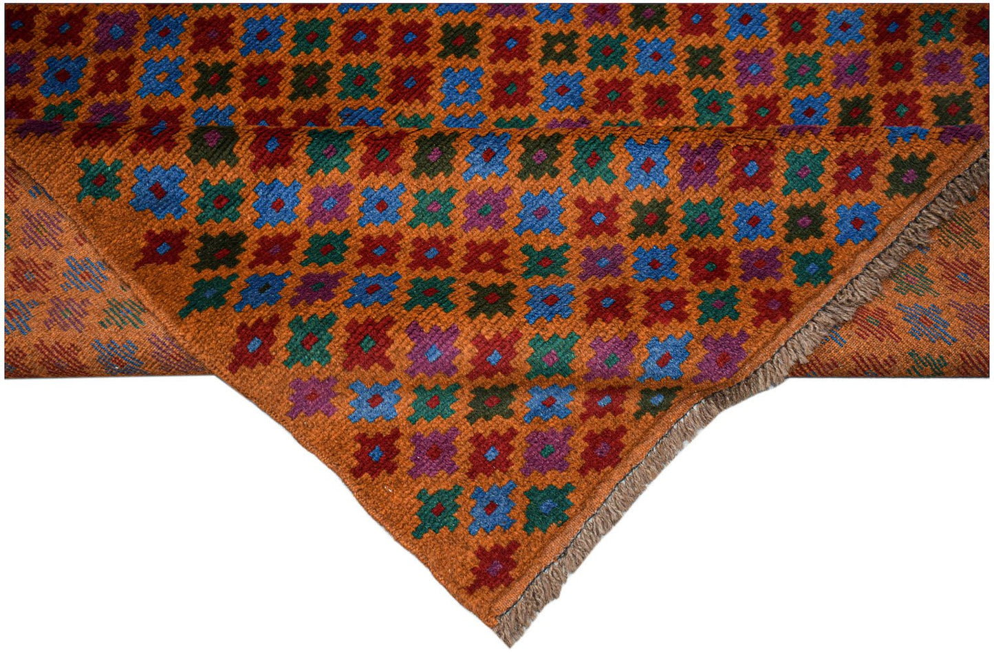 An Afghan Pashm rug featuring a repeating geometric floral pattern in blue, red, green, and purple.
