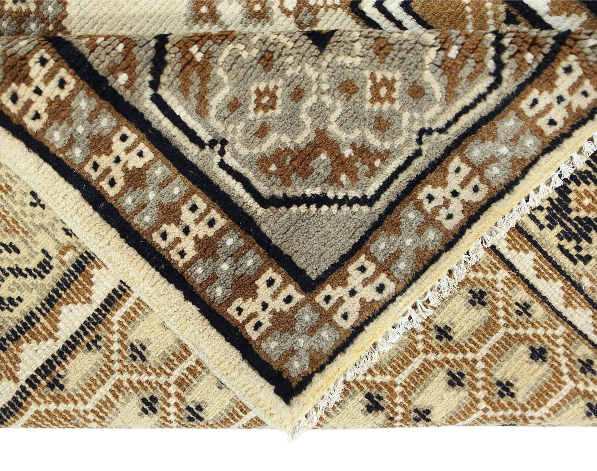 A handwoven Afghan rug featuring geometric tribal motifs in shades of brown and cream.