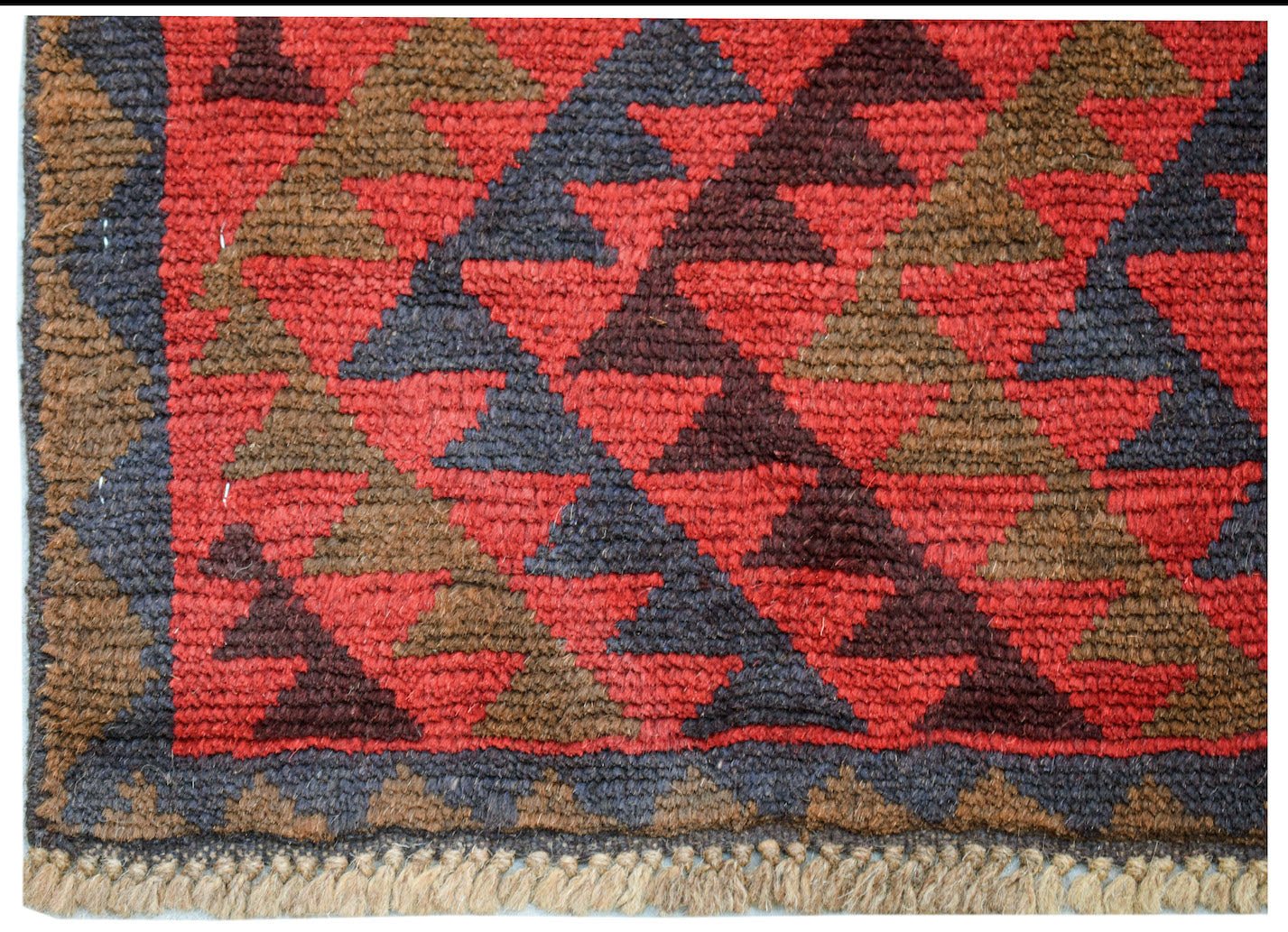 Handmade Afghan Pashm rug featuring a geometric diamond pattern in red, brown, and dark blue.