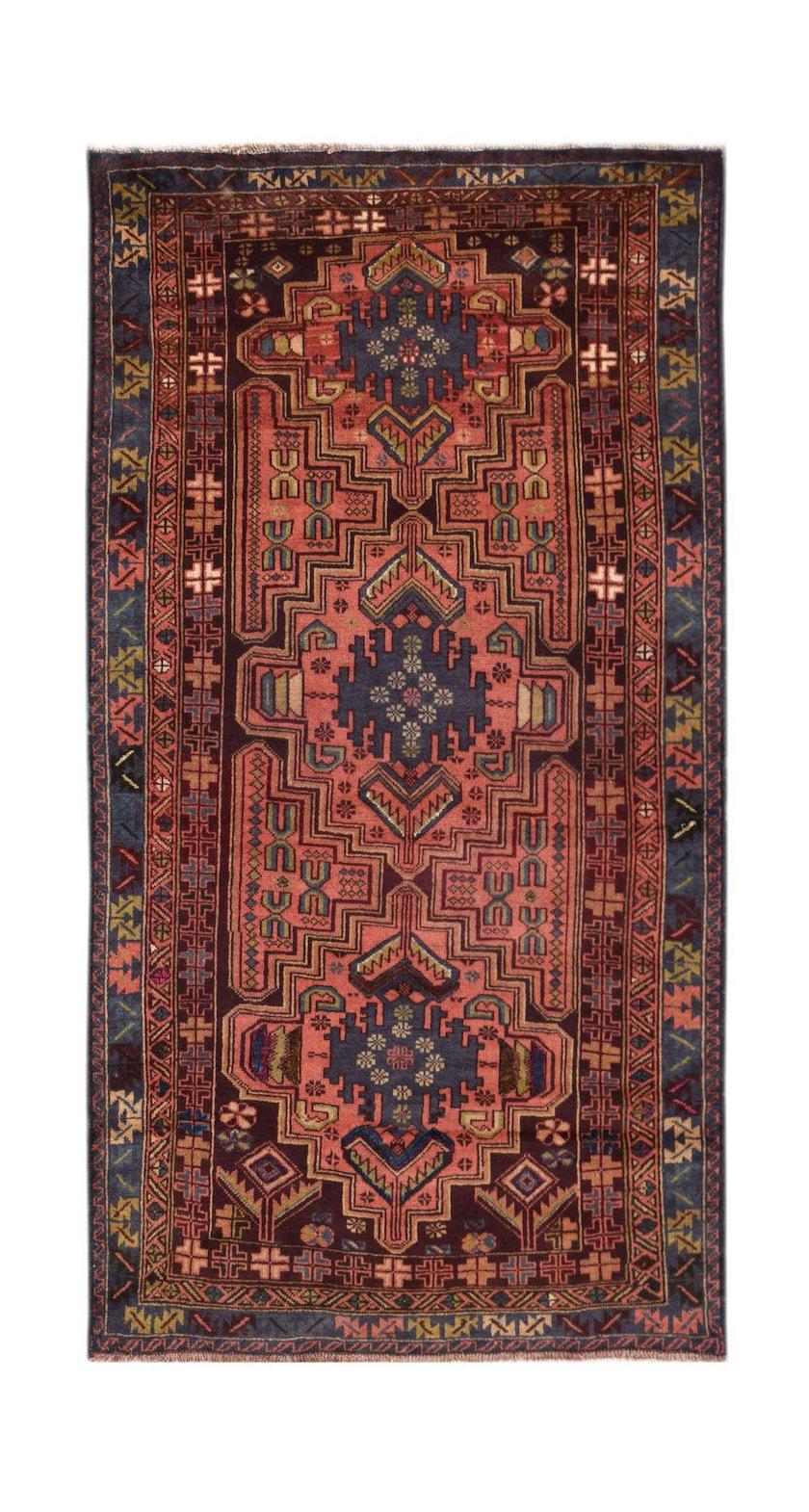 Handmade Afghan Pashm rug featuring a geometric tribal pattern in deep red, blue, and brown tones.