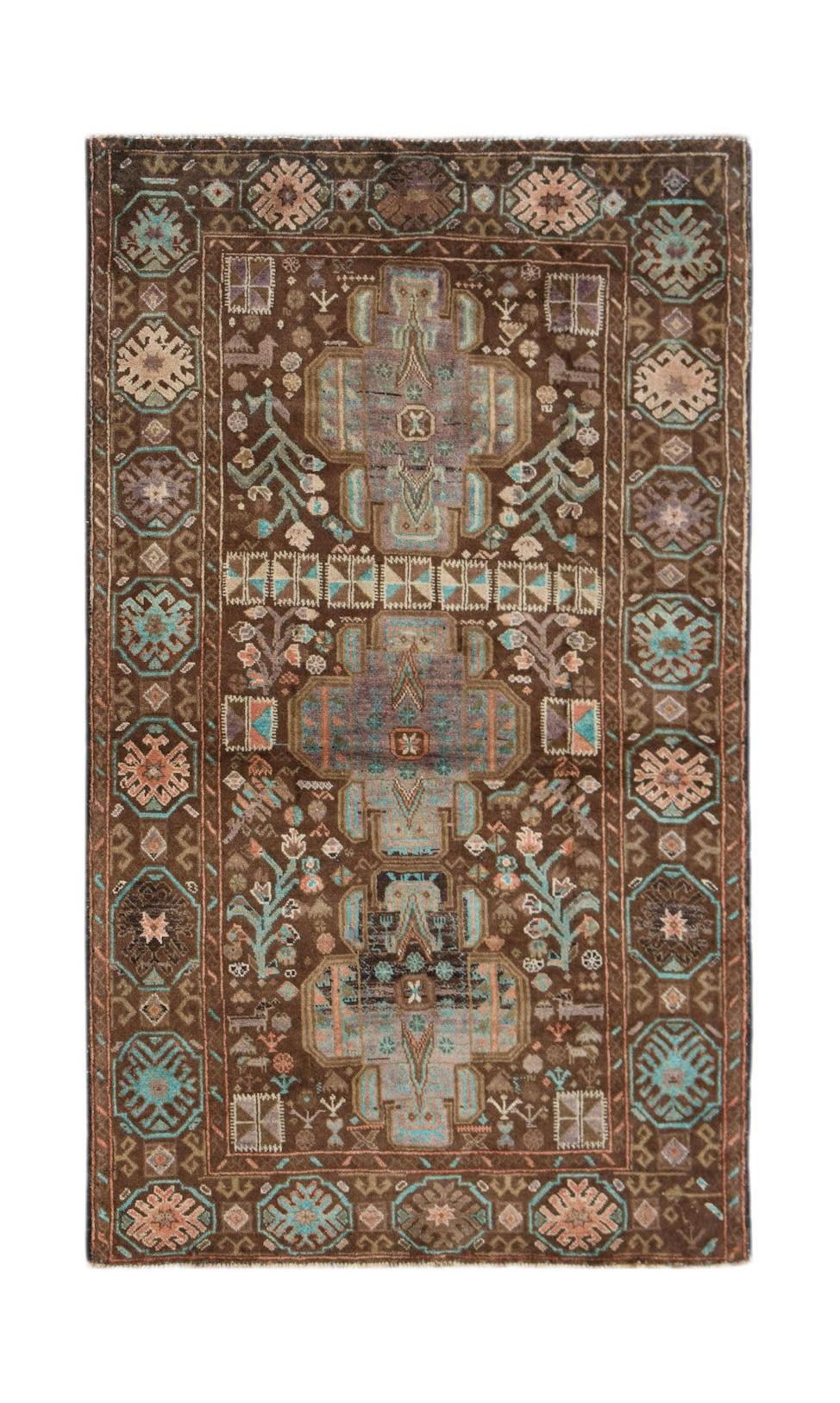 Handmade Afghan Pashm rug featuring a dark brown field with geometric blue and ivory patterns.