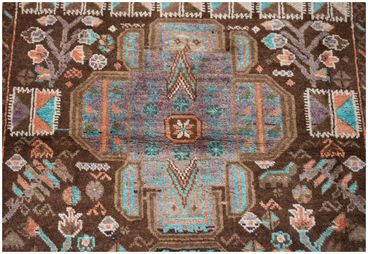 Handmade Afghan Pashm rug featuring a geometric tribal pattern in brown, blue, and orange tones.