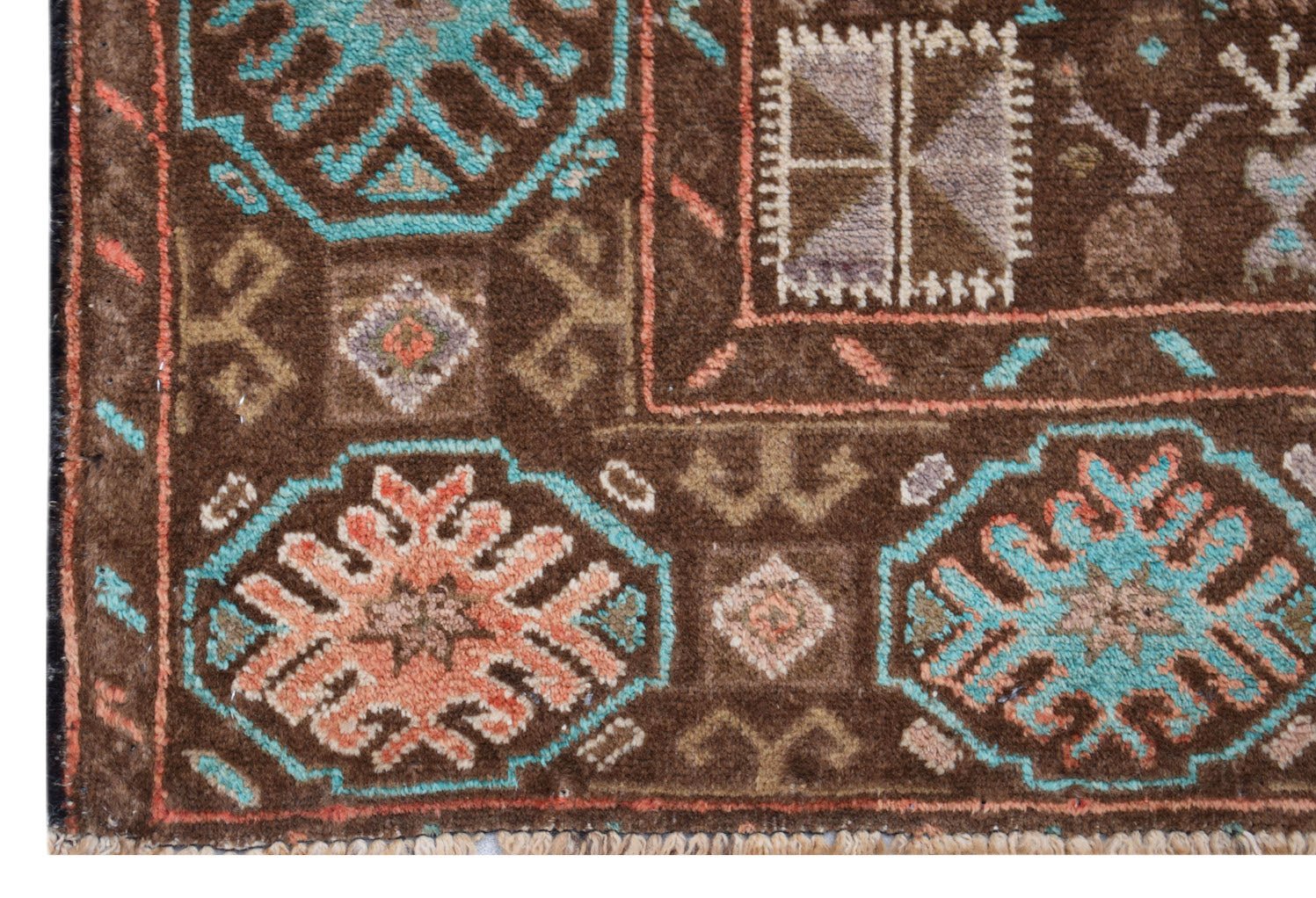 A handmade Afghan Pashm rug featuring geometric floral motifs in blue, orange, and brown.