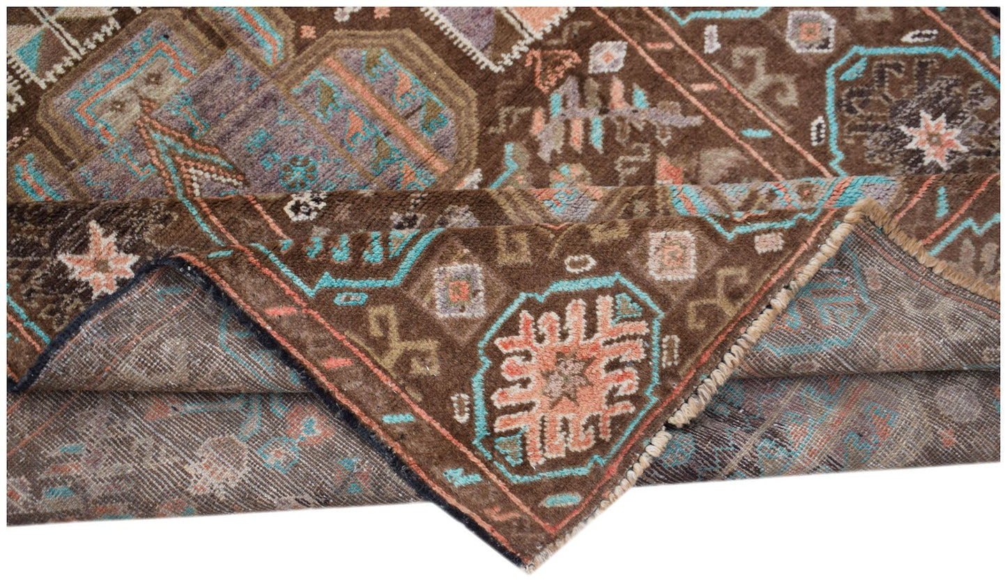 A handmade Afghan Pashm rug featuring traditional tribal geometric patterns in brown and blue.