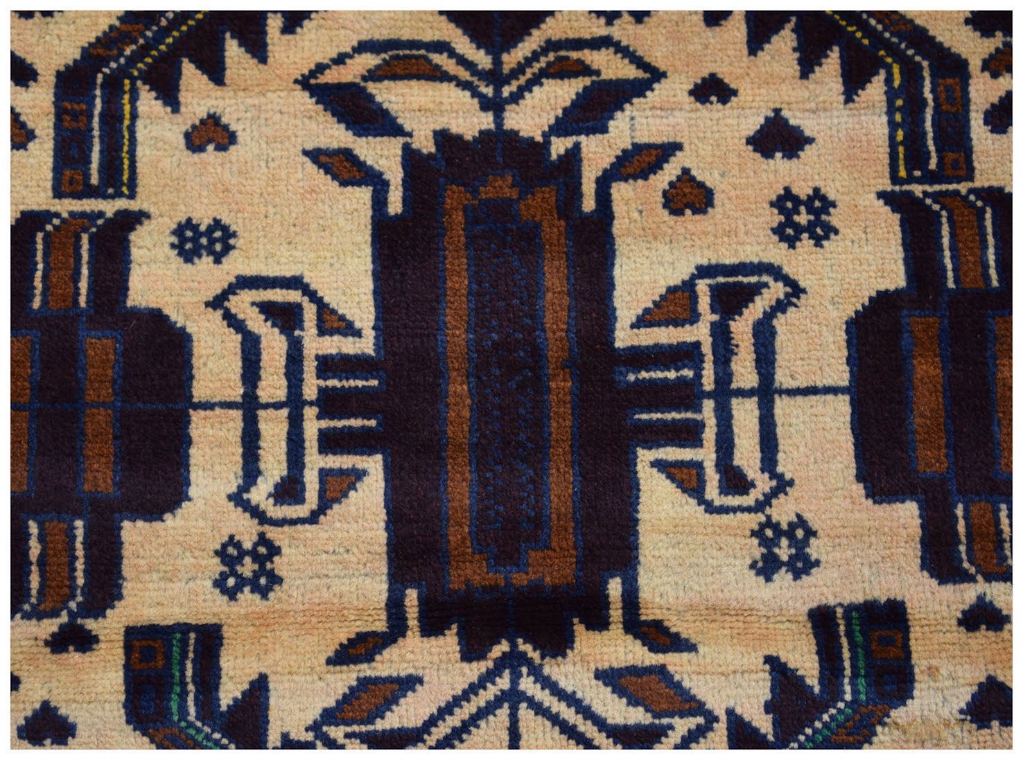 Handmade Afghan Pashm rug featuring a geometric tribal pattern in dark blue, brown, and ivory.
