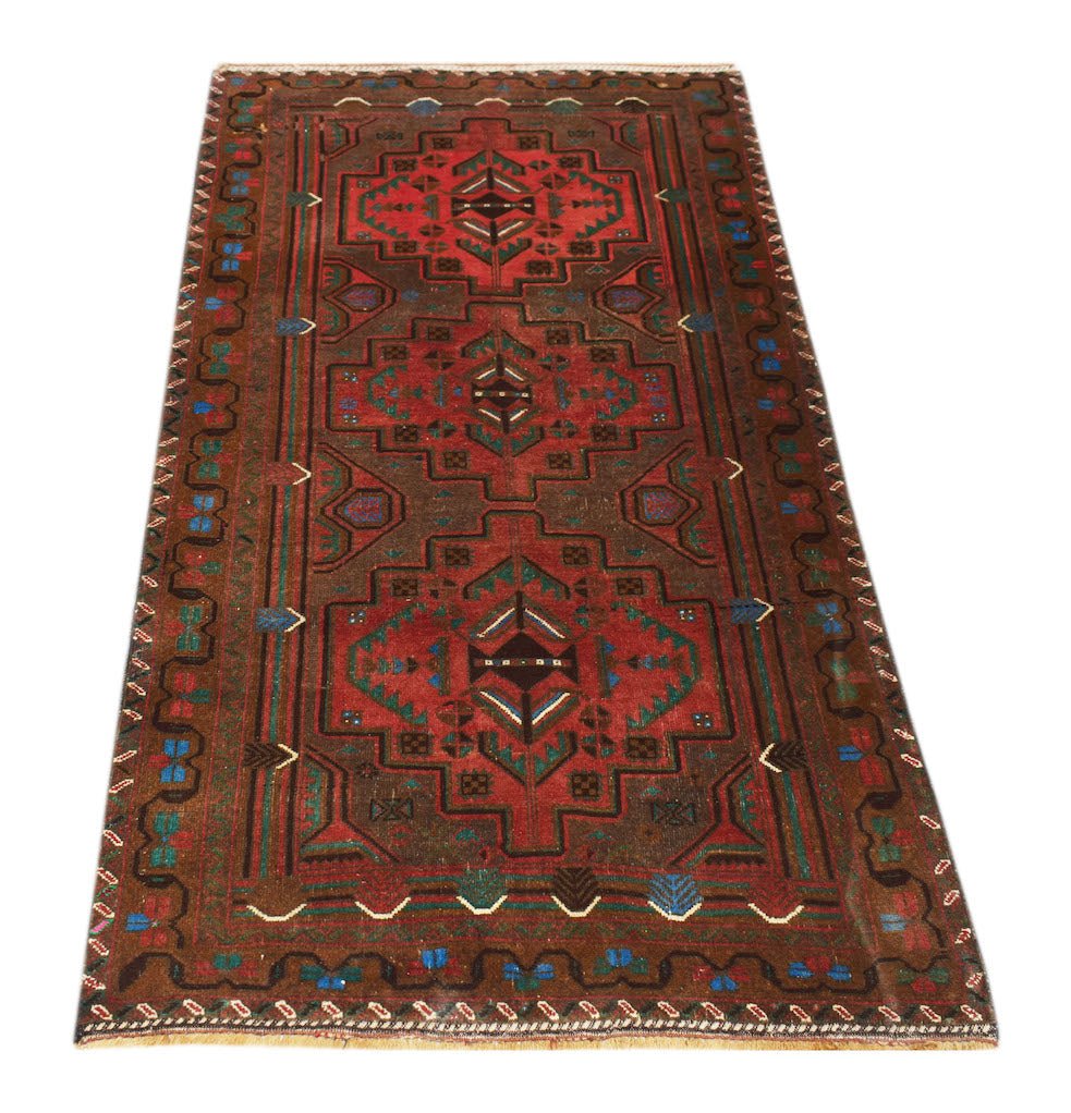 Handmade Afghan Pashm rug featuring a geometric tribal pattern in shades of red, brown, and blue.