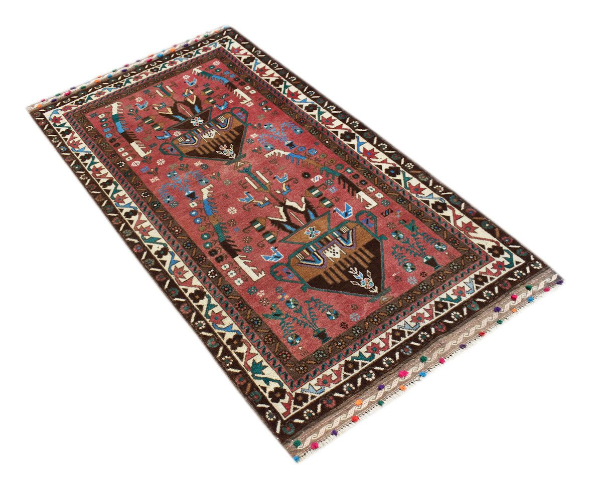 A handmade Afghan Pashm rug featuring a red field with tribal vase motifs and colorful tassels.