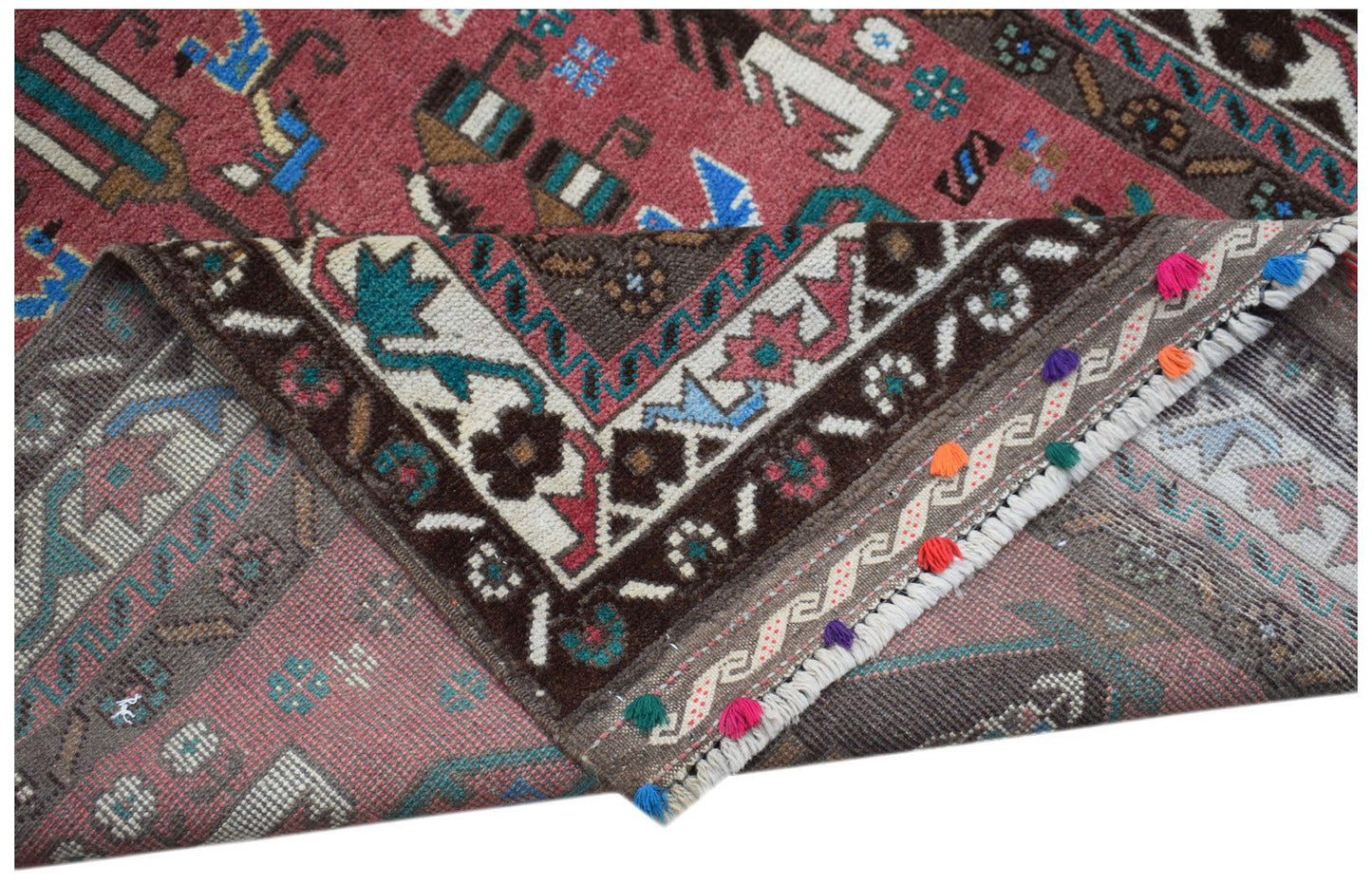 Handmade Afghan Pashm rug featuring traditional tribal patterns in red, brown, and blue tones.