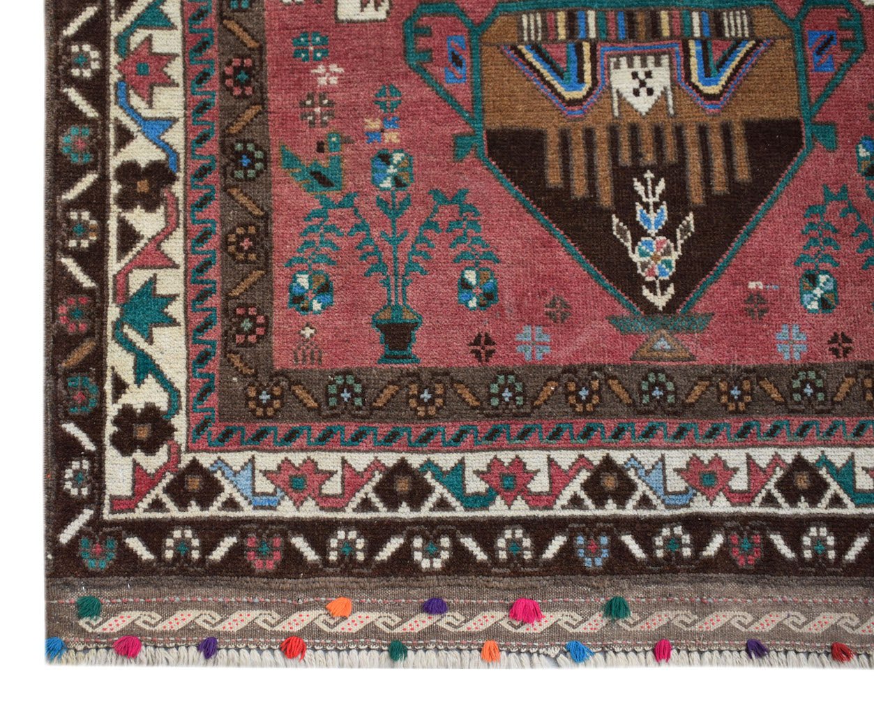 Handmade Afghan Pashm rug featuring a tribal pattern in red, brown, and blue with tassel fringe.