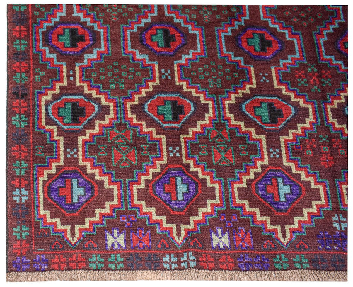 Handmade Afghan Pashm rug featuring a geometric diamond pattern in dark red, blue, and brown.