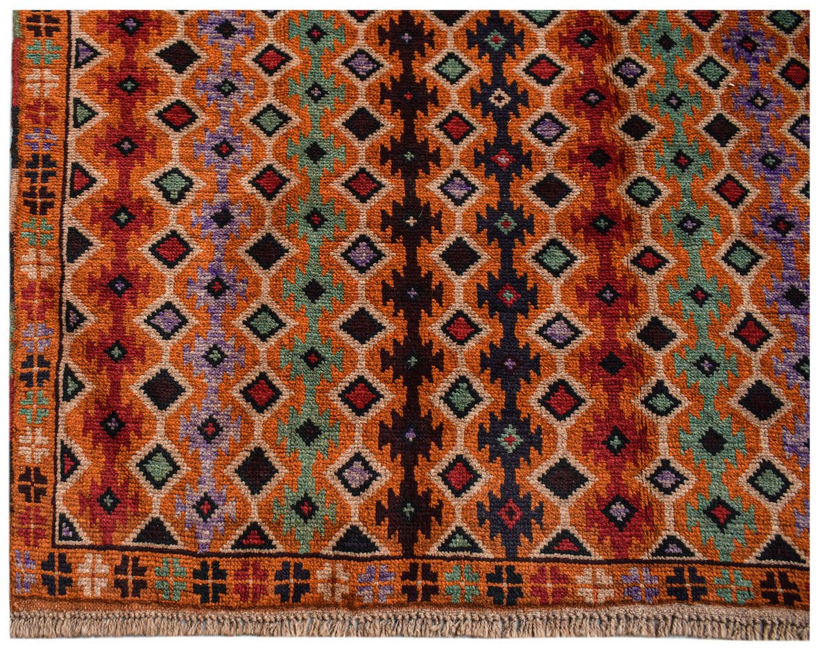 Handmade Afghan Pashm rug featuring a geometric diamond pattern in orange, red, blue, and green.