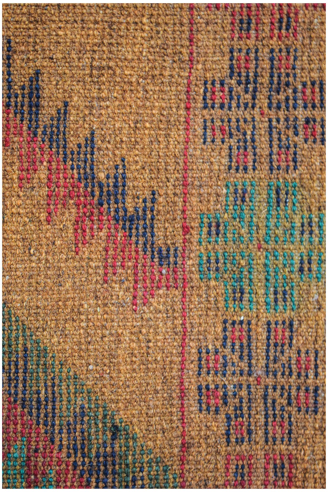 Handmade Afghan Pashm rug featuring a geometric tribal pattern in red, blue, and green on brown.