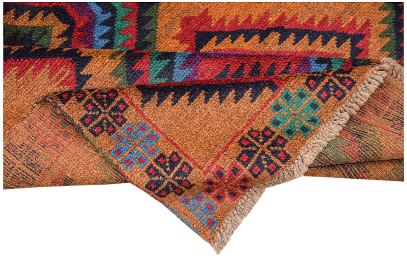 A handmade Afghan Pashm rug featuring traditional tribal geometric patterns in orange and blue.